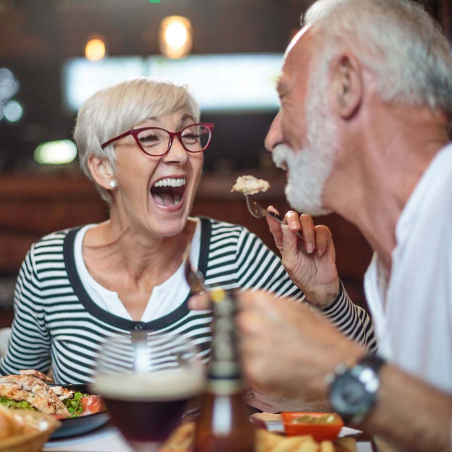 wife feeding her husband in a funny way